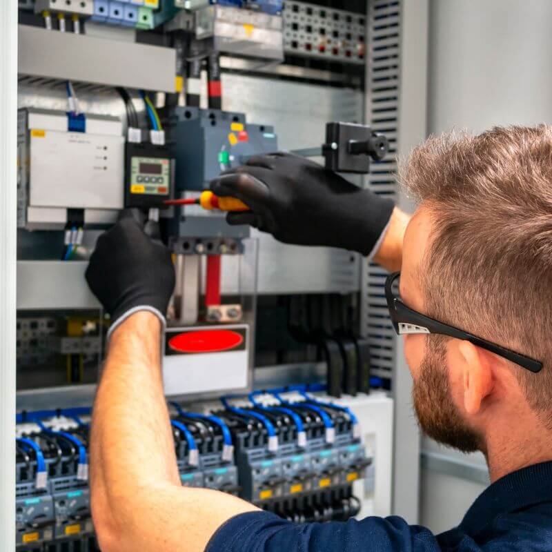 Electrician working on an electrical panel