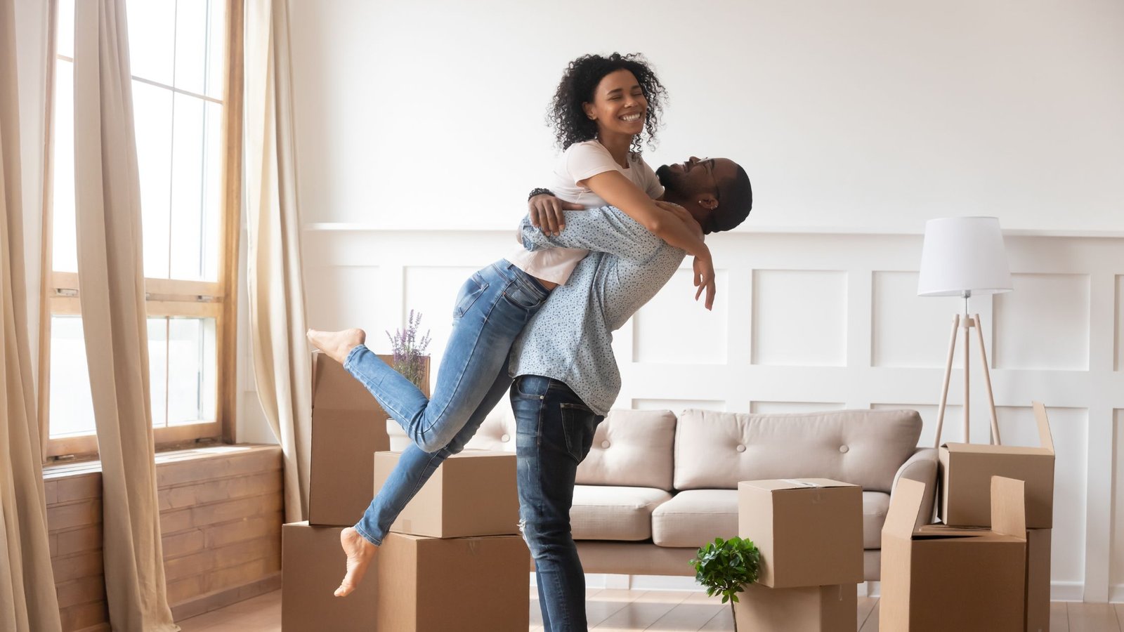 Happy tenants celebrating in apartment