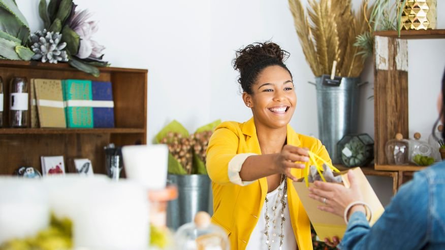 Smiling retail employee helping a customer