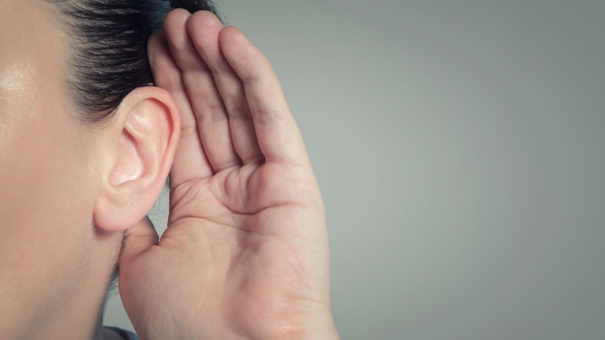 Image of a woman cupping her ear to listen