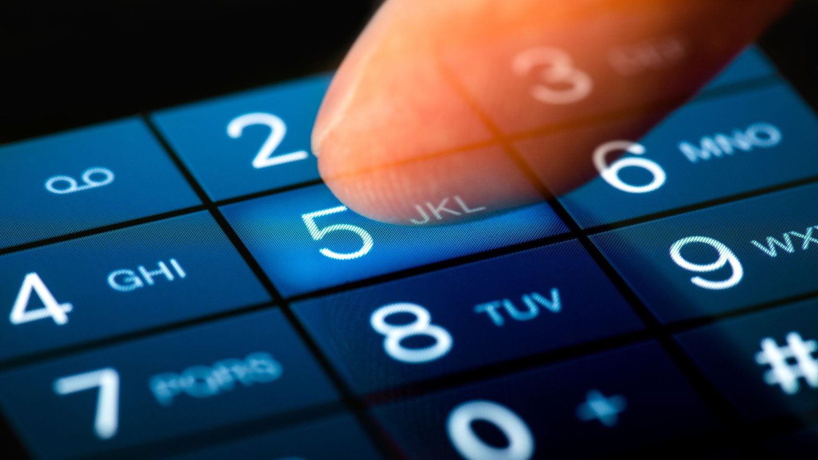 A close-up of a finger dialing the number "5" on a blue phone keypad.