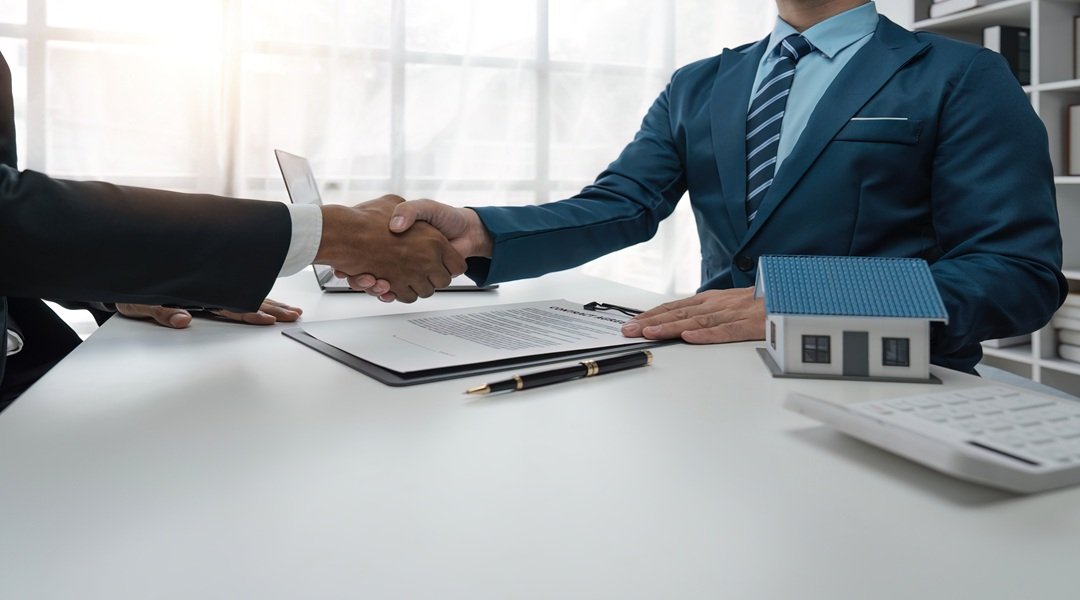 real estate agent shaking hand his client after signing contract,concept for real estate, moving home or renting property